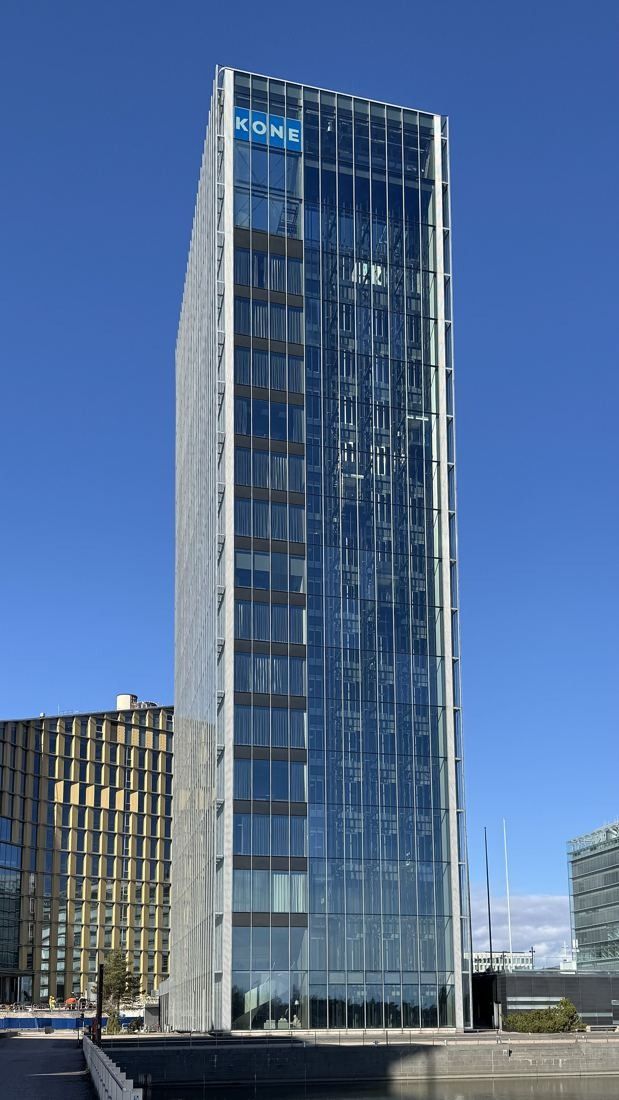 KONE: Tall glass office tower with a street in the foreground