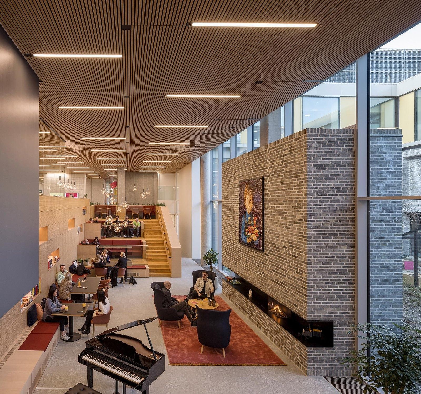 The LEGO Group: Lounge with a brick fireplace wall and a piano