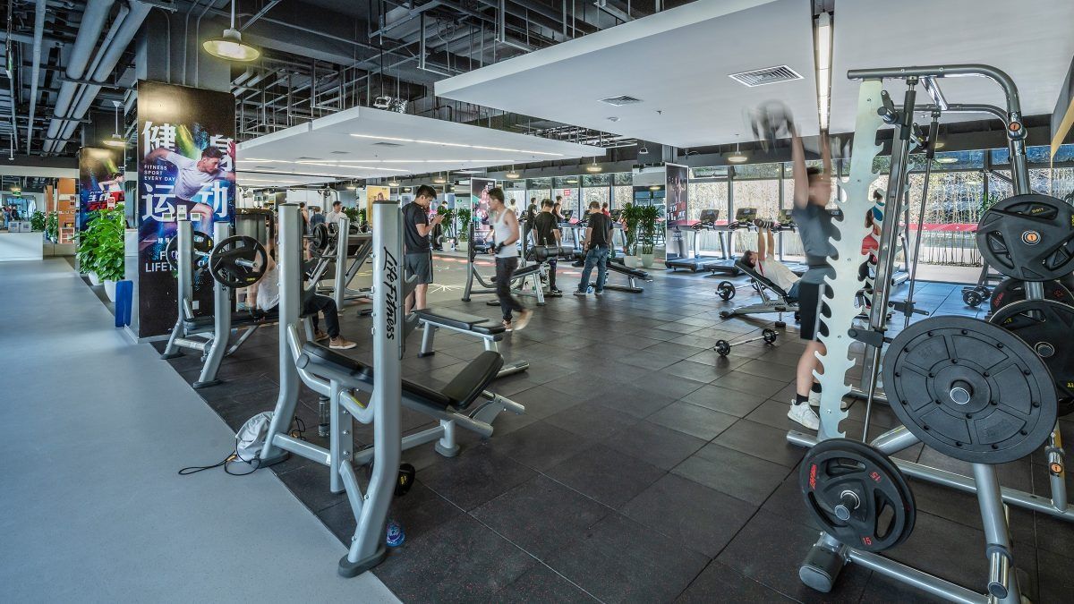 Lenovo: Gym with weight machines by the windows