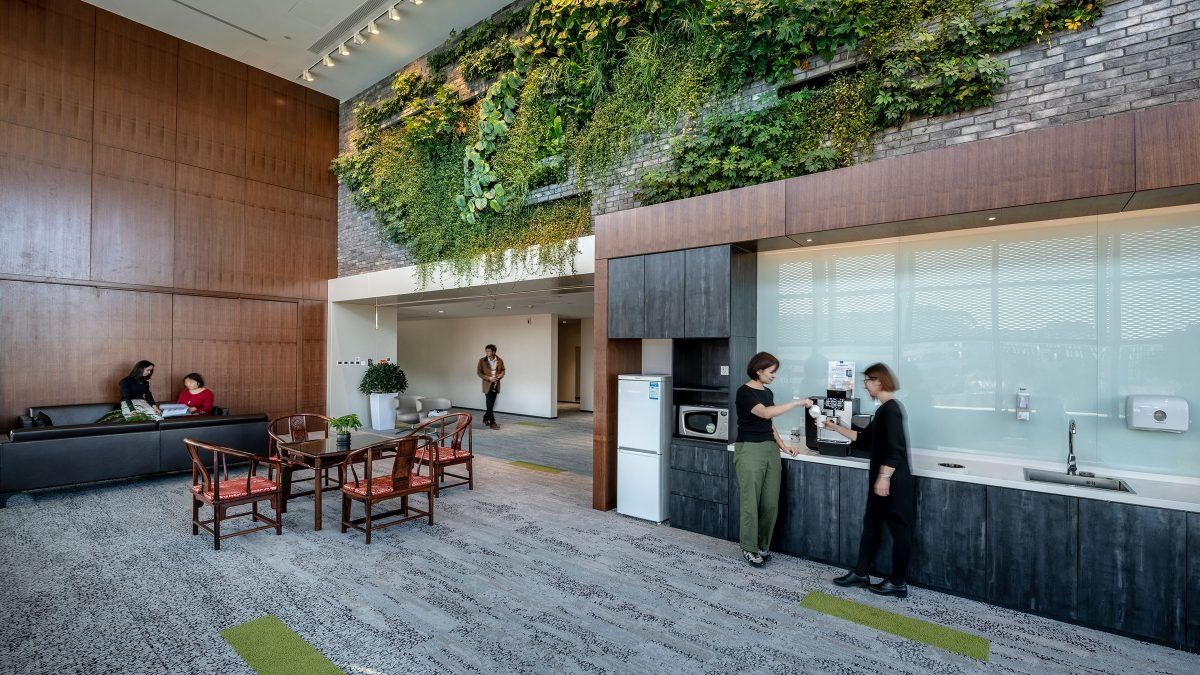 Lenovo: Kitchen area below a planted wall and timber panels