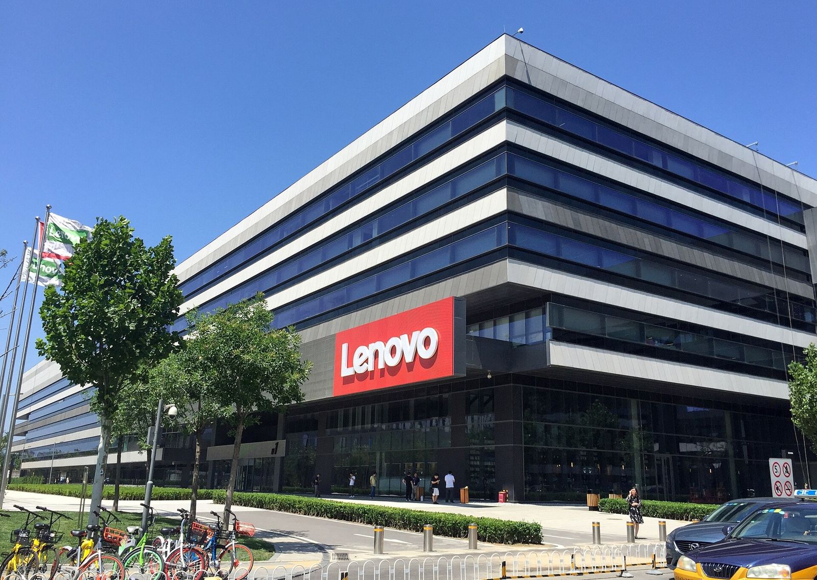 Lenovo: Office building with blue glass bands and a red Lenovo sign