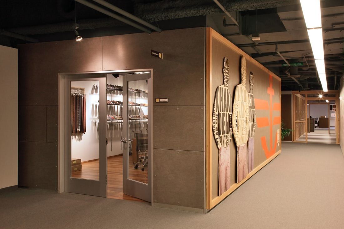 Levi Strauss & Co.: Corridor with glass doors set into a wood-clad wall with large graphic panels