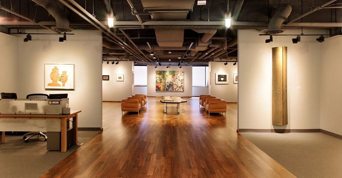 Levi Strauss & Co.: Gallery-like room with wood floor, framed pictures on white walls and low seating