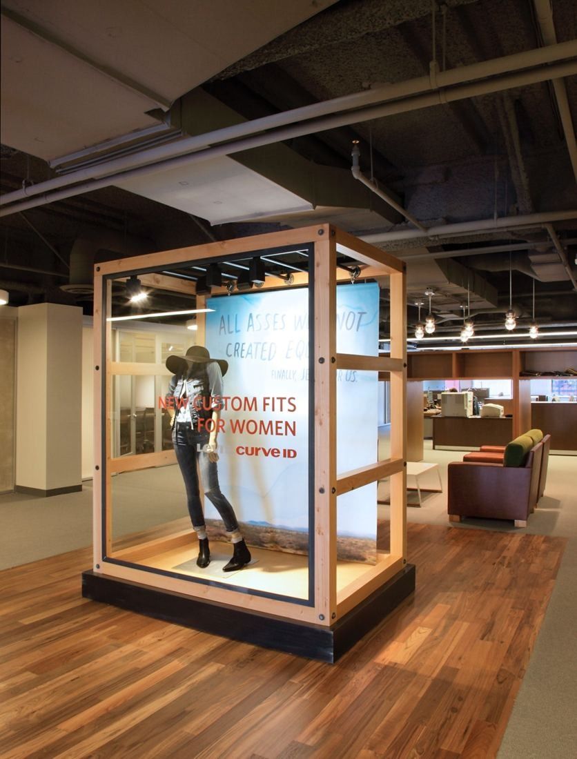 Levi Strauss & Co.: Glass and wood display case with a mannequin wearing denim on a wood floor