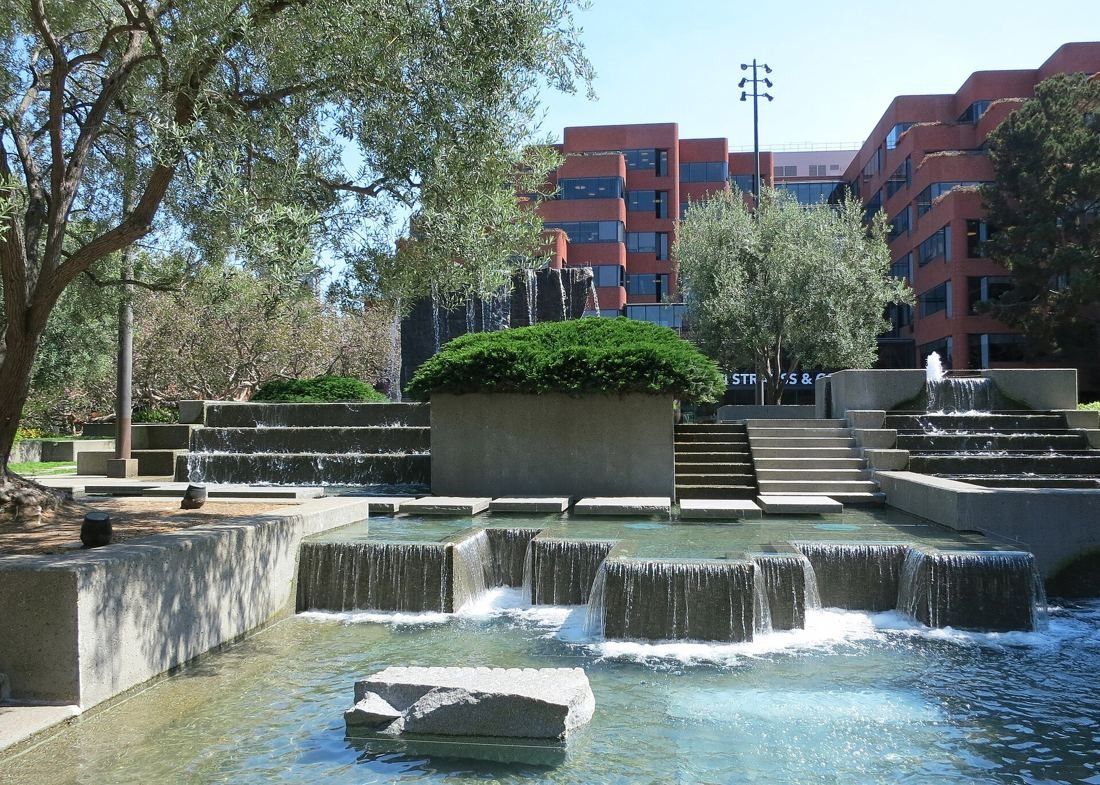 Levi Strauss & Co.: Granite fountain with cascading water in front of brick buildings and trees