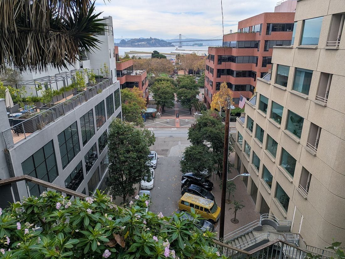 Levi Strauss & Co.: View down a hillside stair toward brick buildings and the bay
