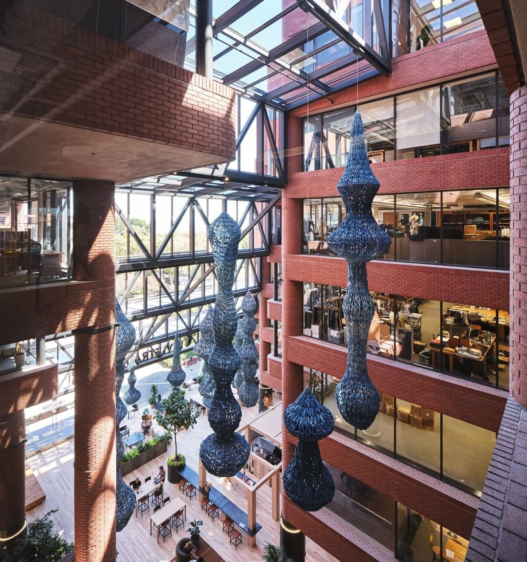 Levi Strauss & Co.: View down into the atrium past hanging blue sculptures and brick balconies