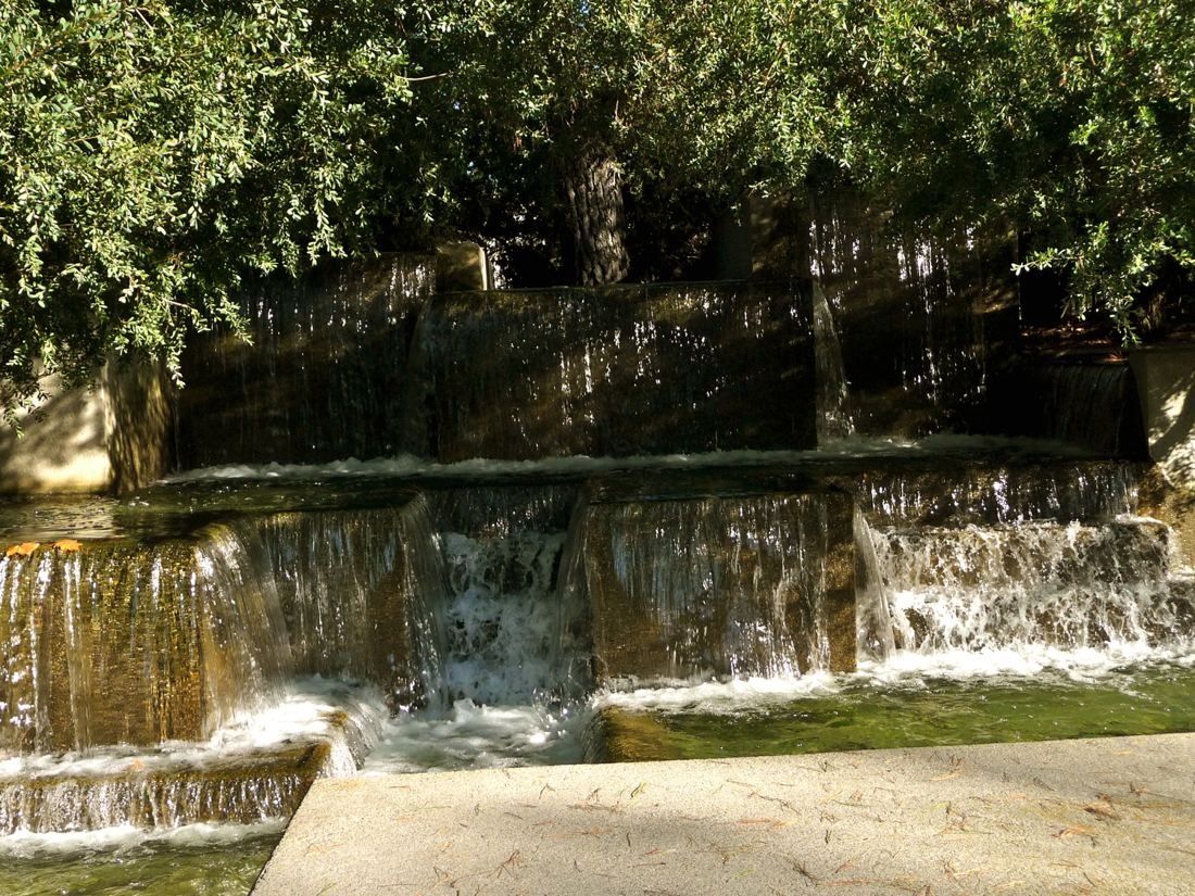 Levi Strauss & Co.: Water cascading over layered stone ledges under trees