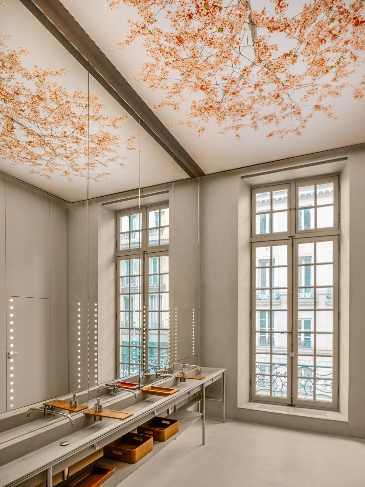 L'Oréal: A tall room with French windows and a pink ceiling installation