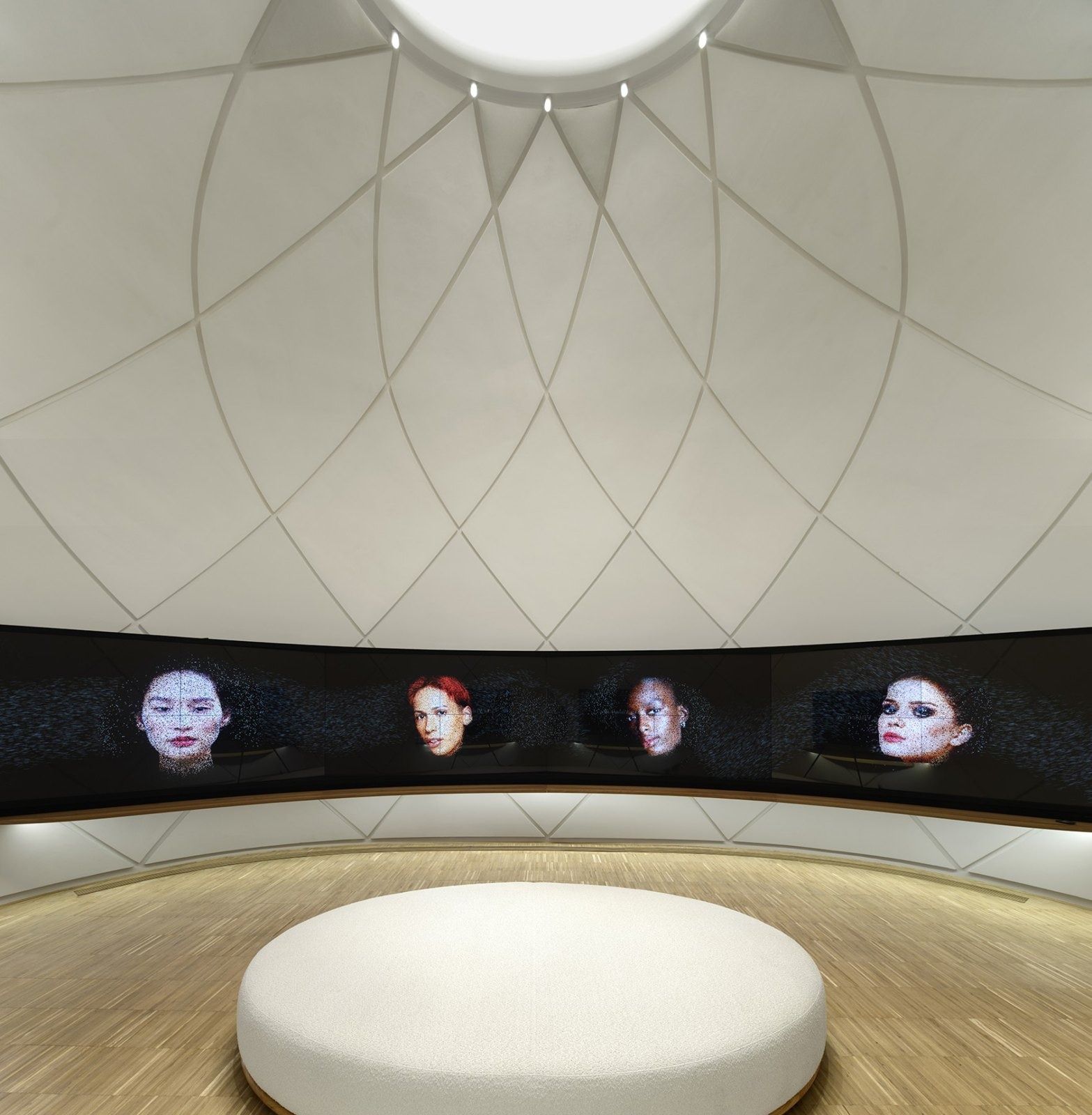 L'Oréal: A white domed room with a circular bench and screens