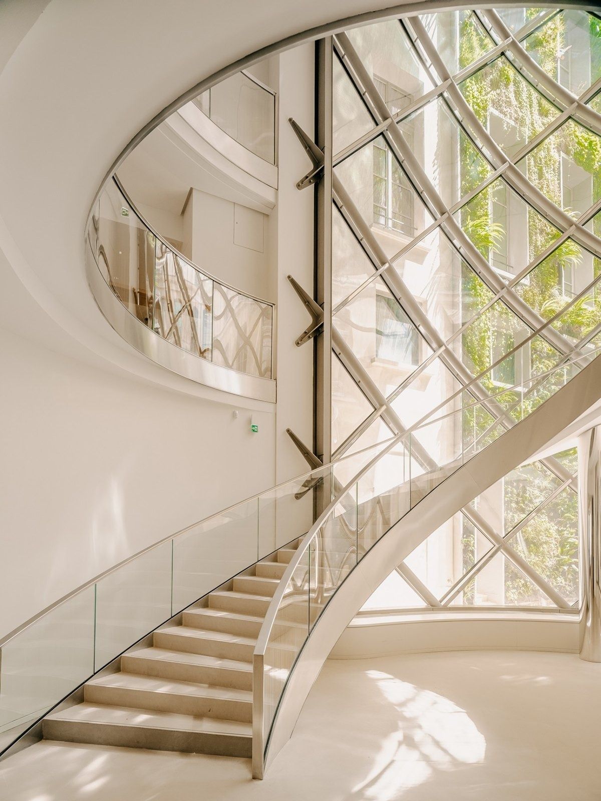 L'Oréal: A white stair curving up beside a lattice wall