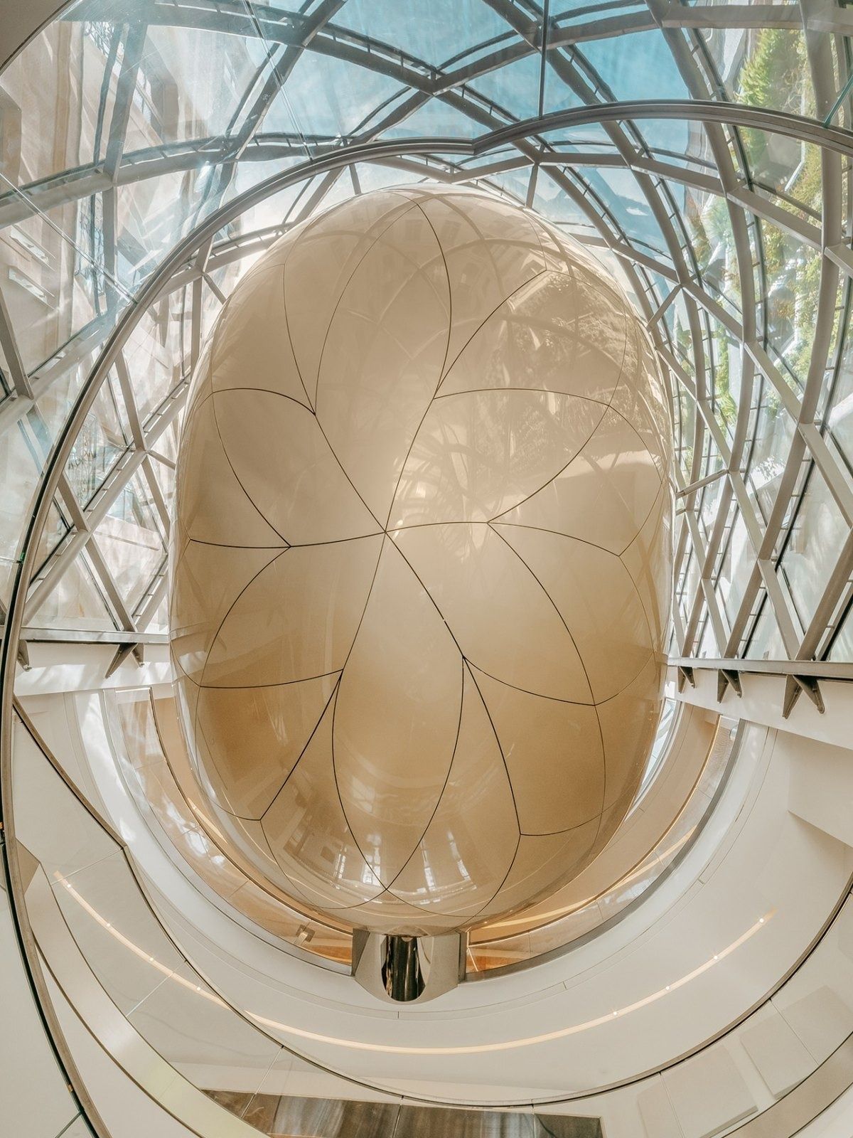 L'Oréal: Looking up into a golden ovoid inside the glass lattice