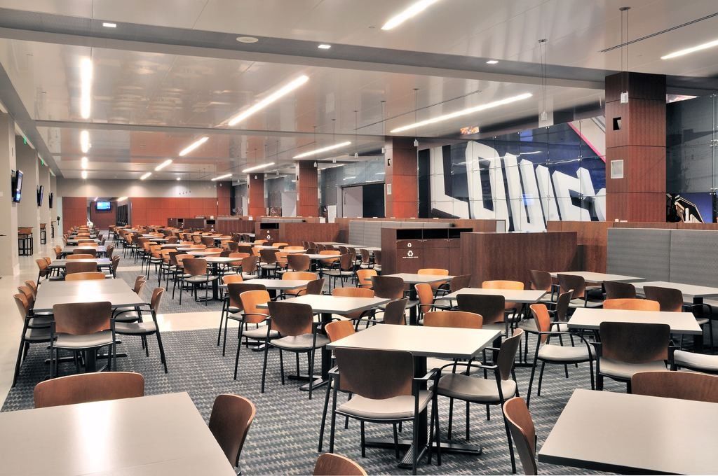 Lowe's: Large dining hall with rows of tables and chairs and a big LOWES lettering sculpture