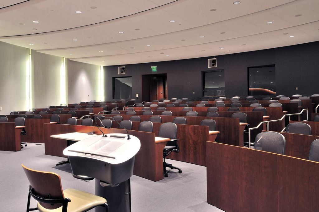 Lowe's: Tiered auditorium seen from the front, with a lectern and rows of curved desks