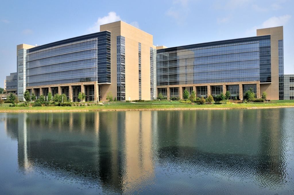 Lowe's: Two glass office towers reflected in a calm lake