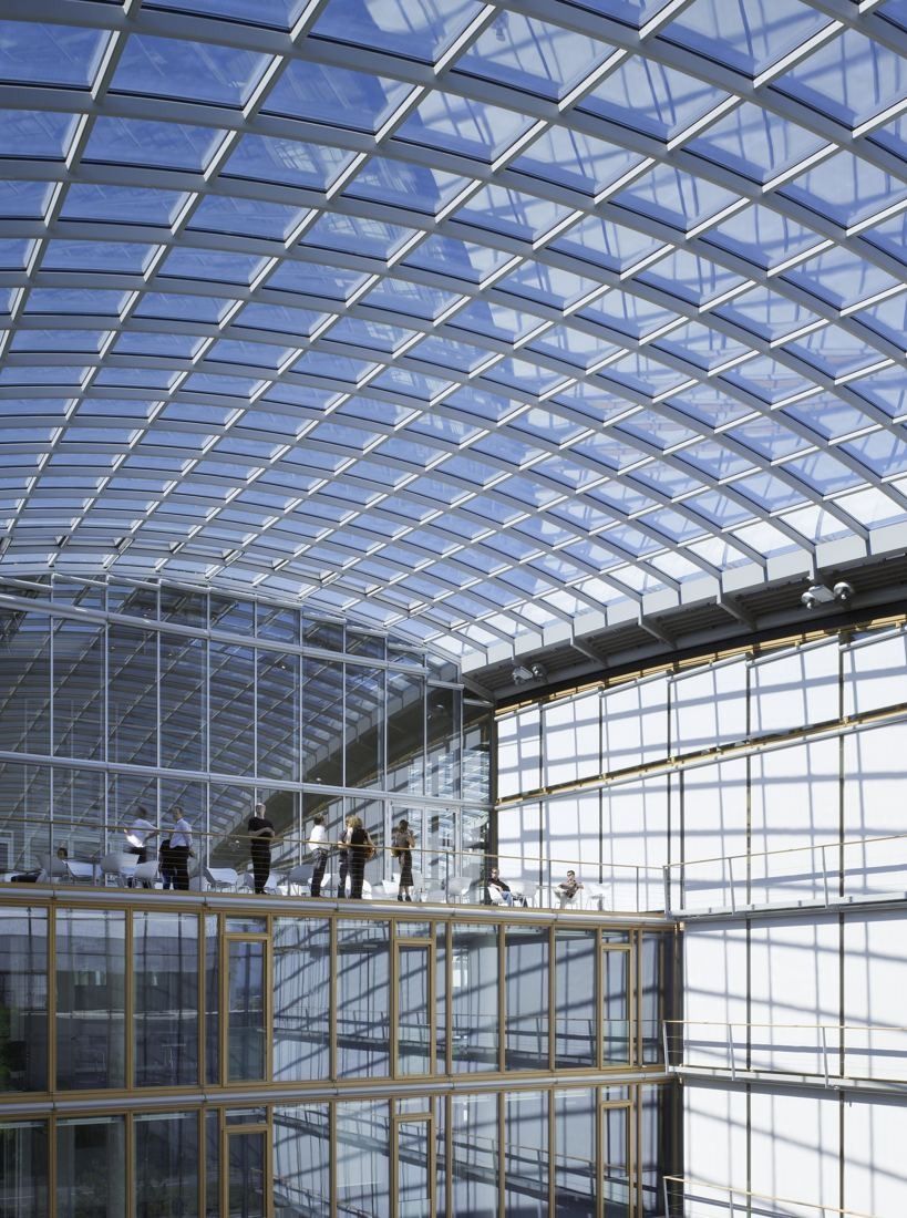 Lufthansa Group: Tall atrium under a curved glass roof with walkways along the facades