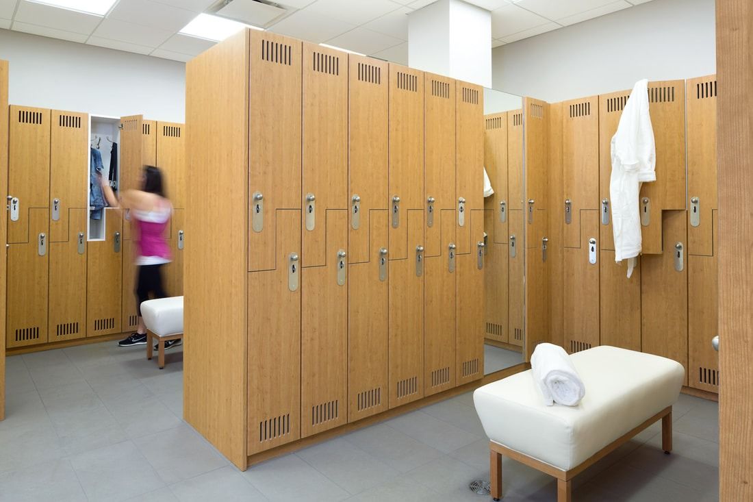 lululemon athletica: Changing room with wooden lockers and a white bench