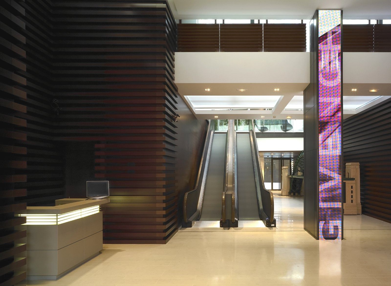 LVMH: A lobby with escalators and a reception desk