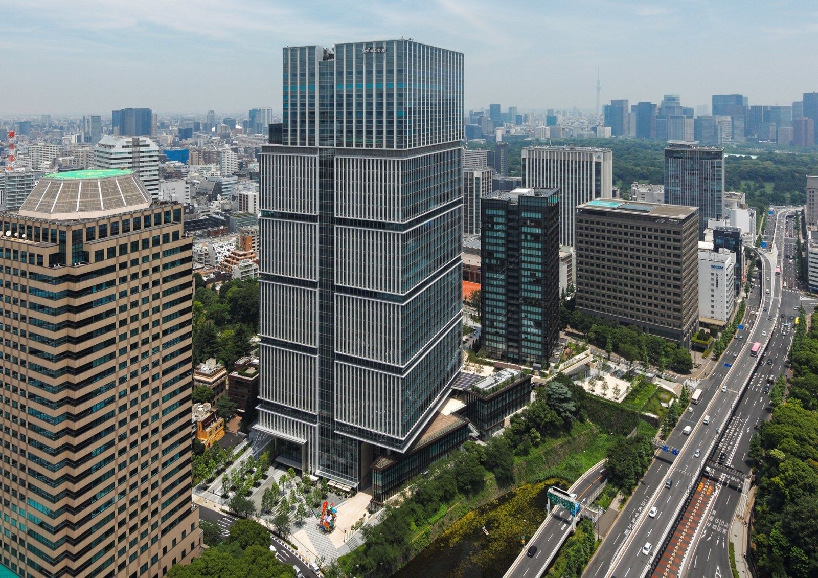 LY Corporation: Aerial view of the tower beside a moat and green slopes