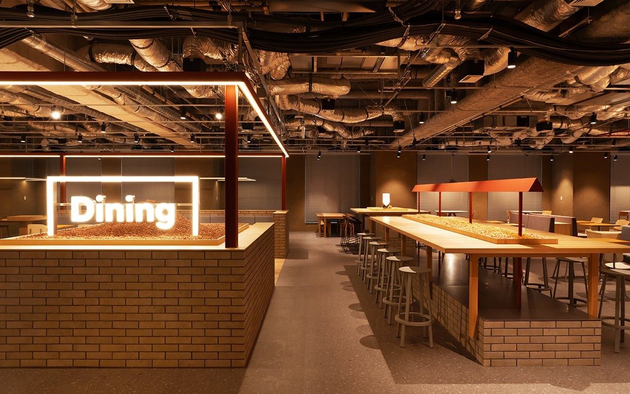 LY Corporation: Brick-clad dining counter with a lit Dining sign