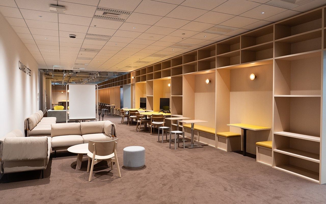 LY Corporation: Long lounge with sofas and timber shelving booths