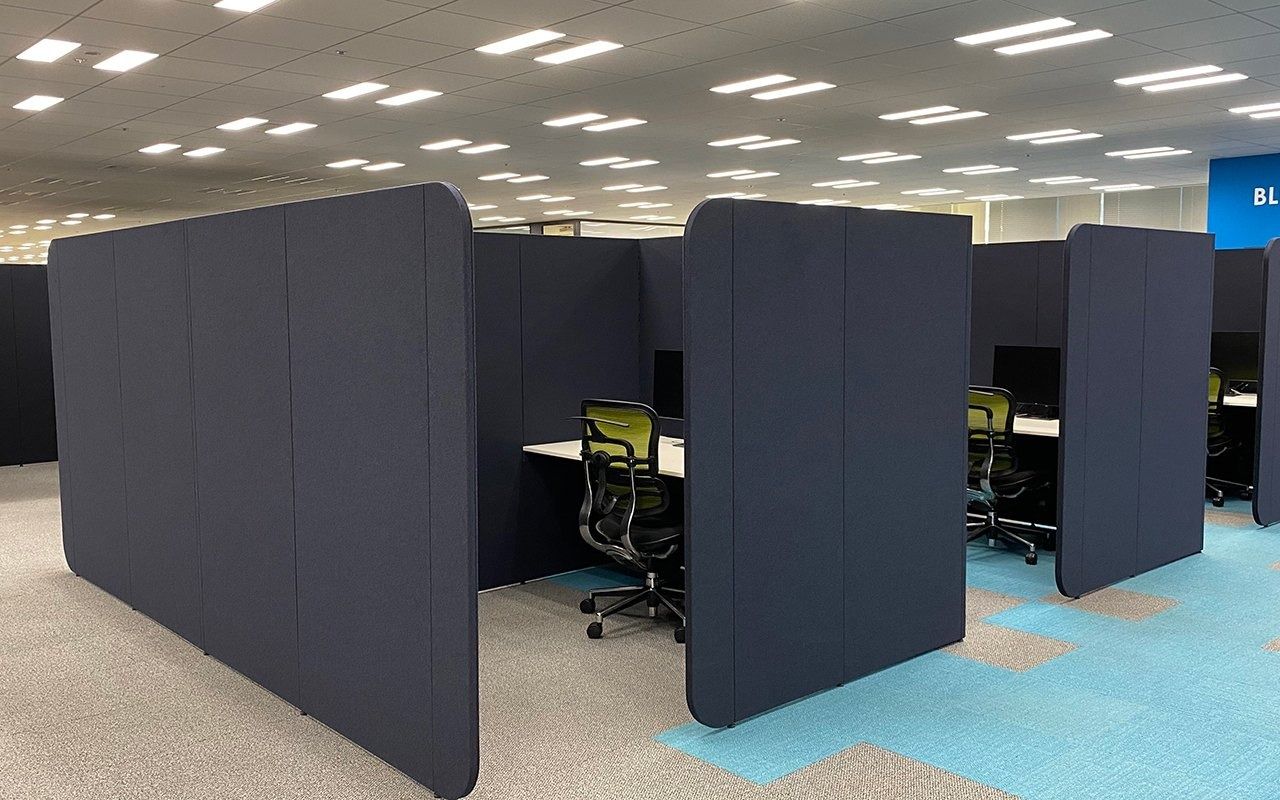 LY Corporation: Rows of desks separated by dark rounded booth panels