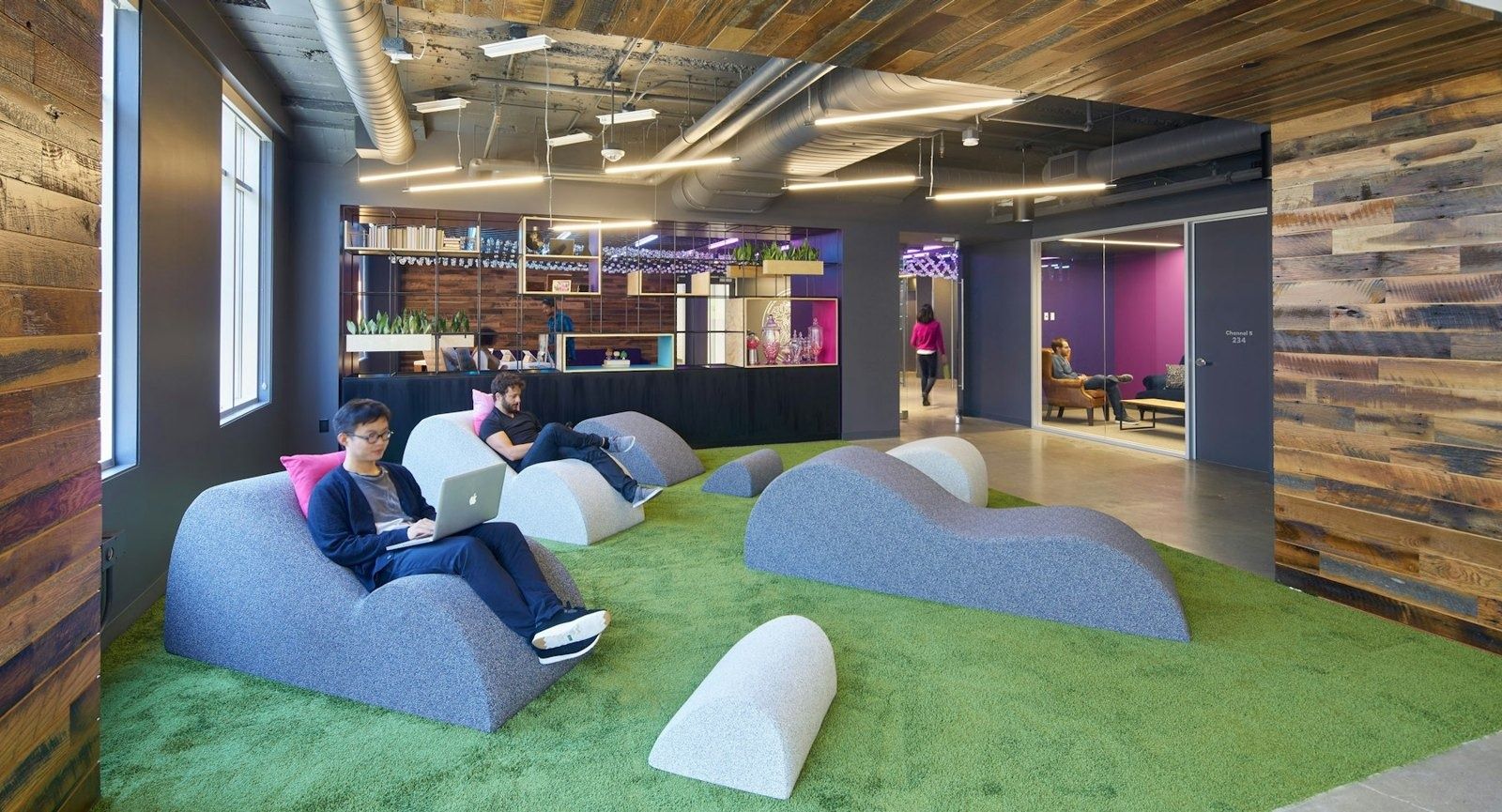 Lyft: Lounge chairs on green turf among timber planters