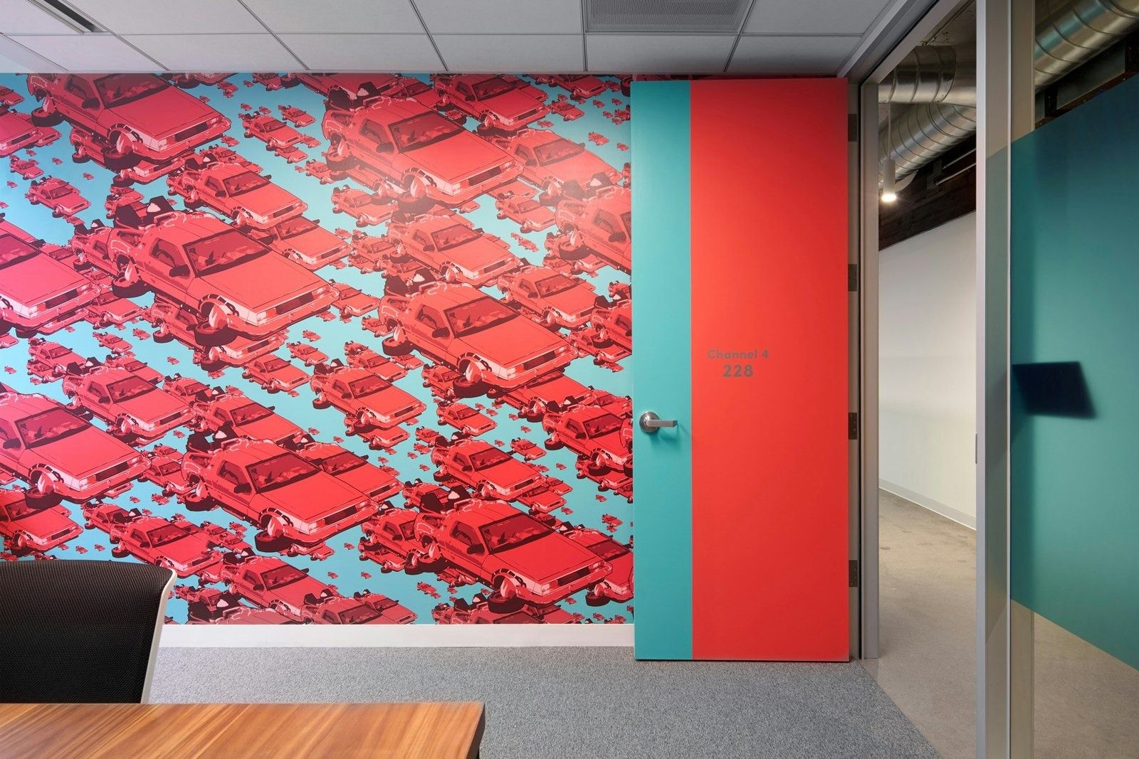Lyft: Wall graphic of red cars next to a teal door