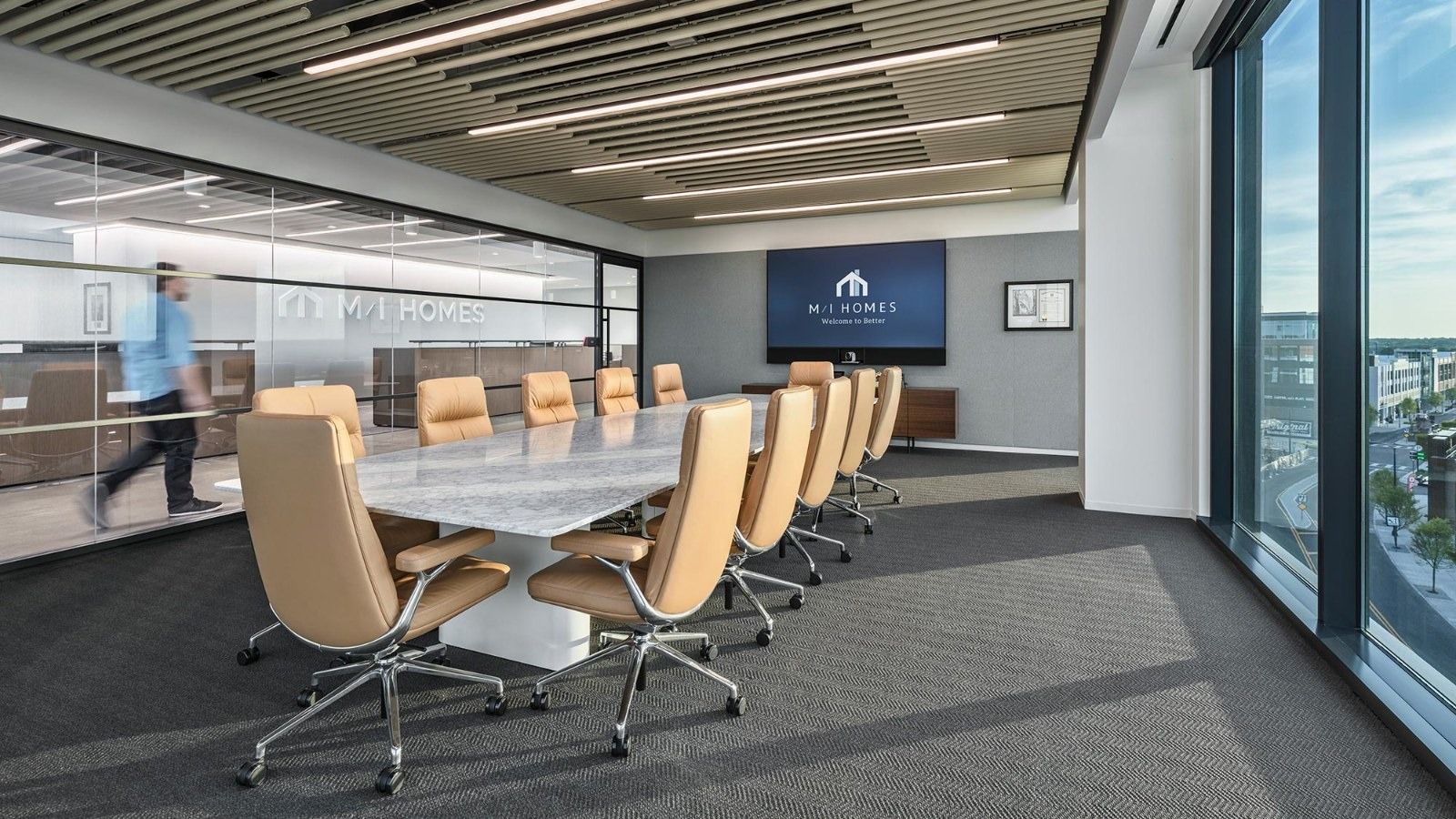M/I Homes: A boardroom with tan chairs and city views