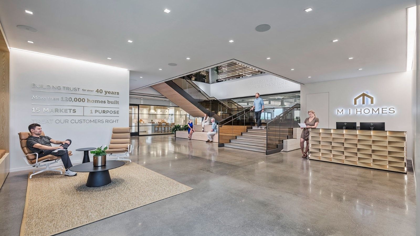 M/I Homes: A lobby with a wide stair and a wood reception desk