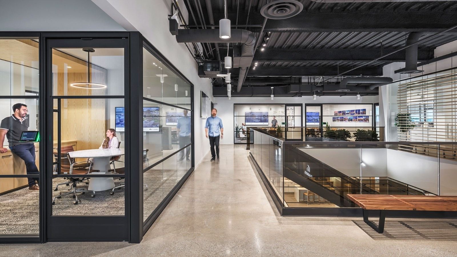 M/I Homes: Glass meeting rooms beside an open stair