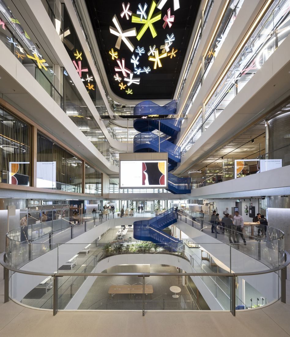 Macquarie Group: Atrium seen from below, with a blue staircase and a colourful ceiling artwork