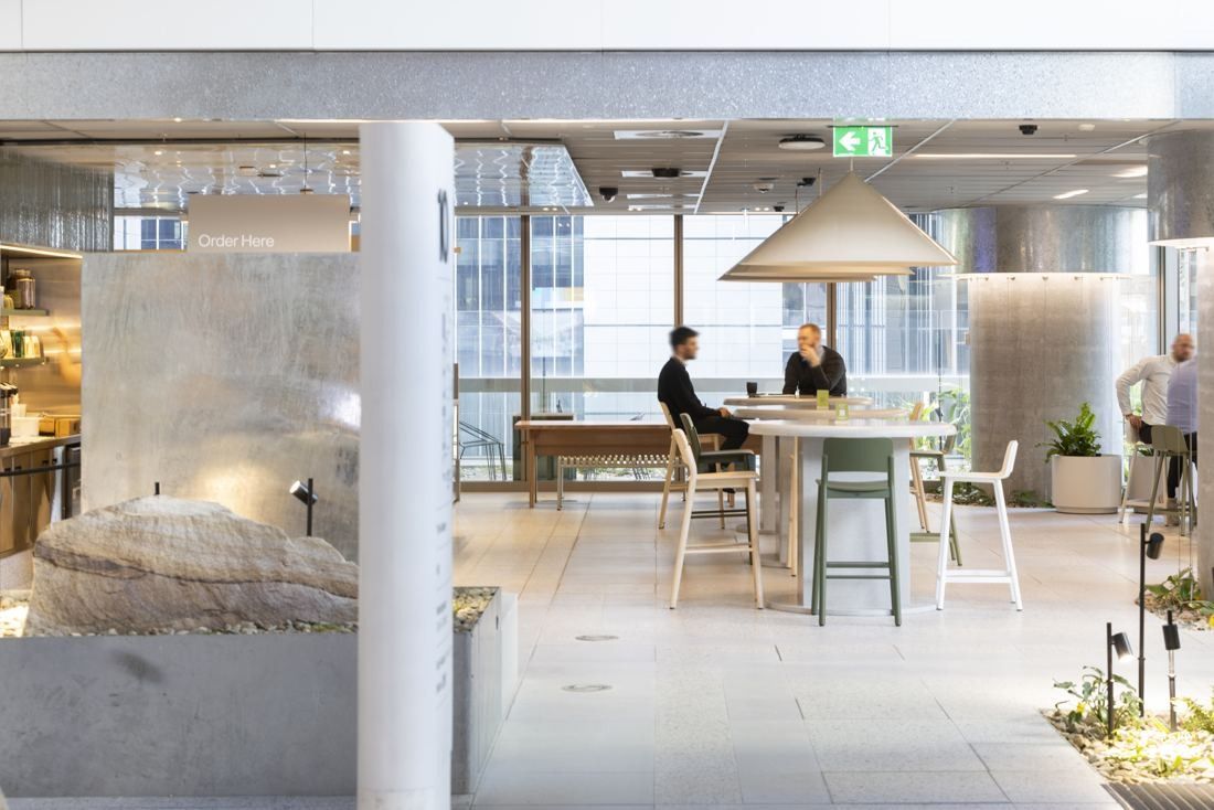 Macquarie Group: Bright workspace with high tables and a pendant lamp