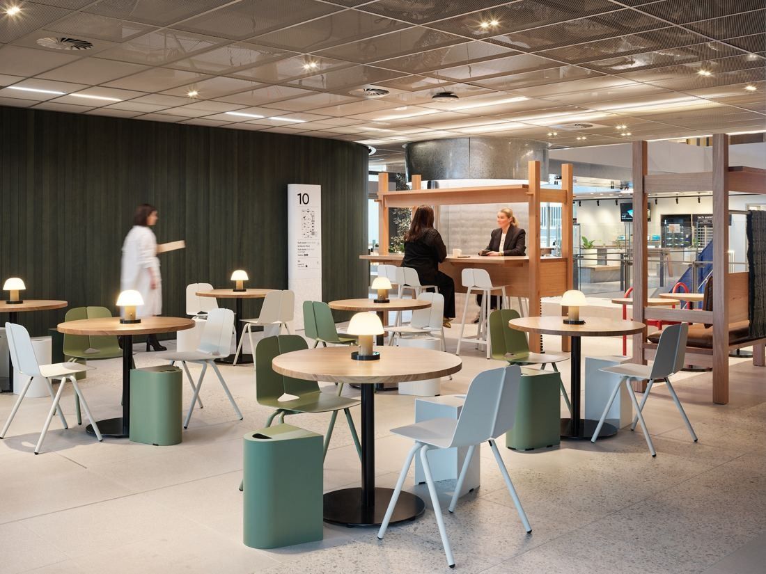 Macquarie Group: Café-style area with round tables, green chairs and small lamps