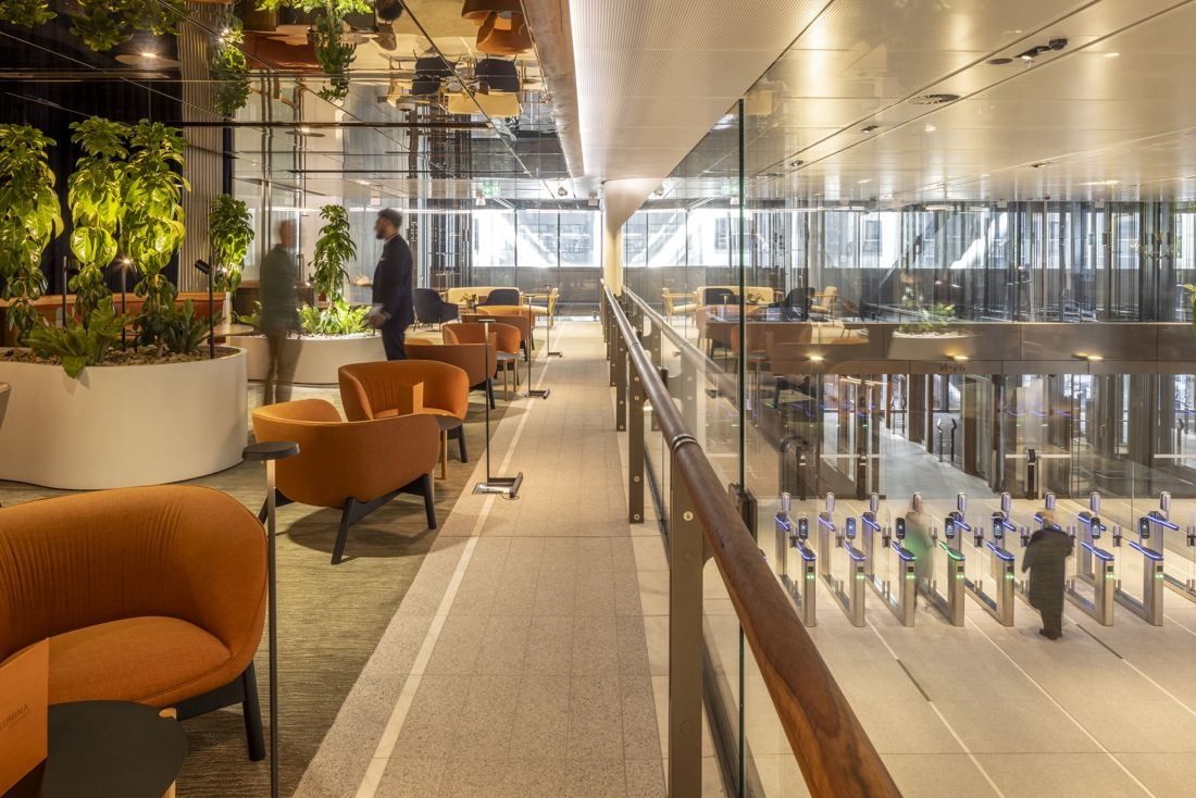 Macquarie Group: Lounge chairs along a glass balustrade above ticket gates