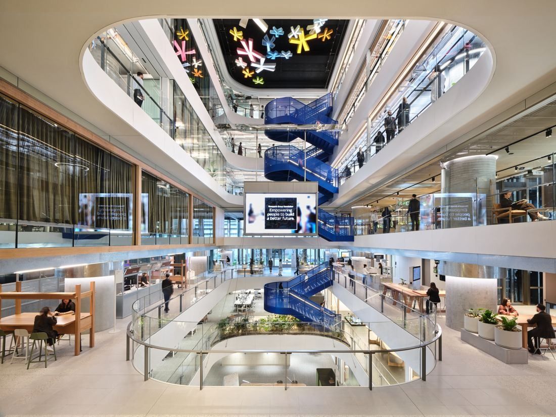 Macquarie Group: Multi-storey atrium with a blue spiral staircase and open work floors