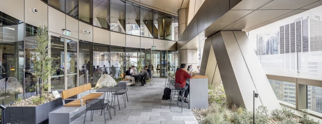 Macquarie Group: Outdoor terrace with planters, tables and city views under an angled column