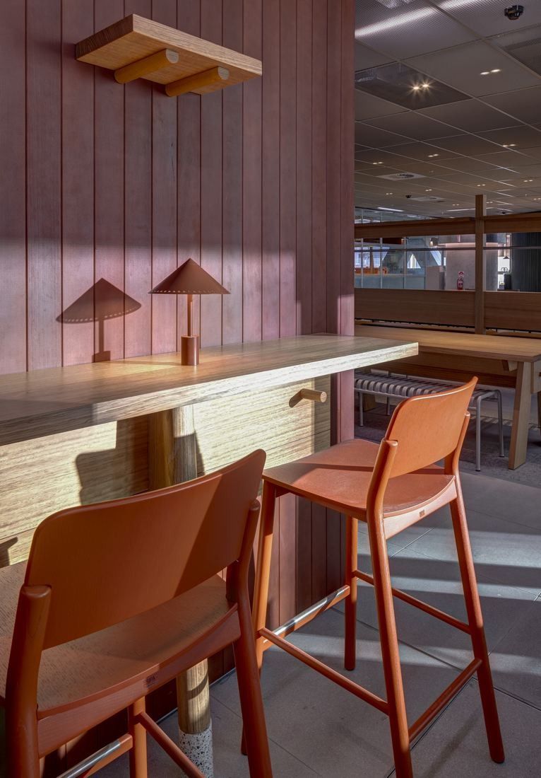 Macquarie Group: Pink-toned bar counter with orange stools and table lamps