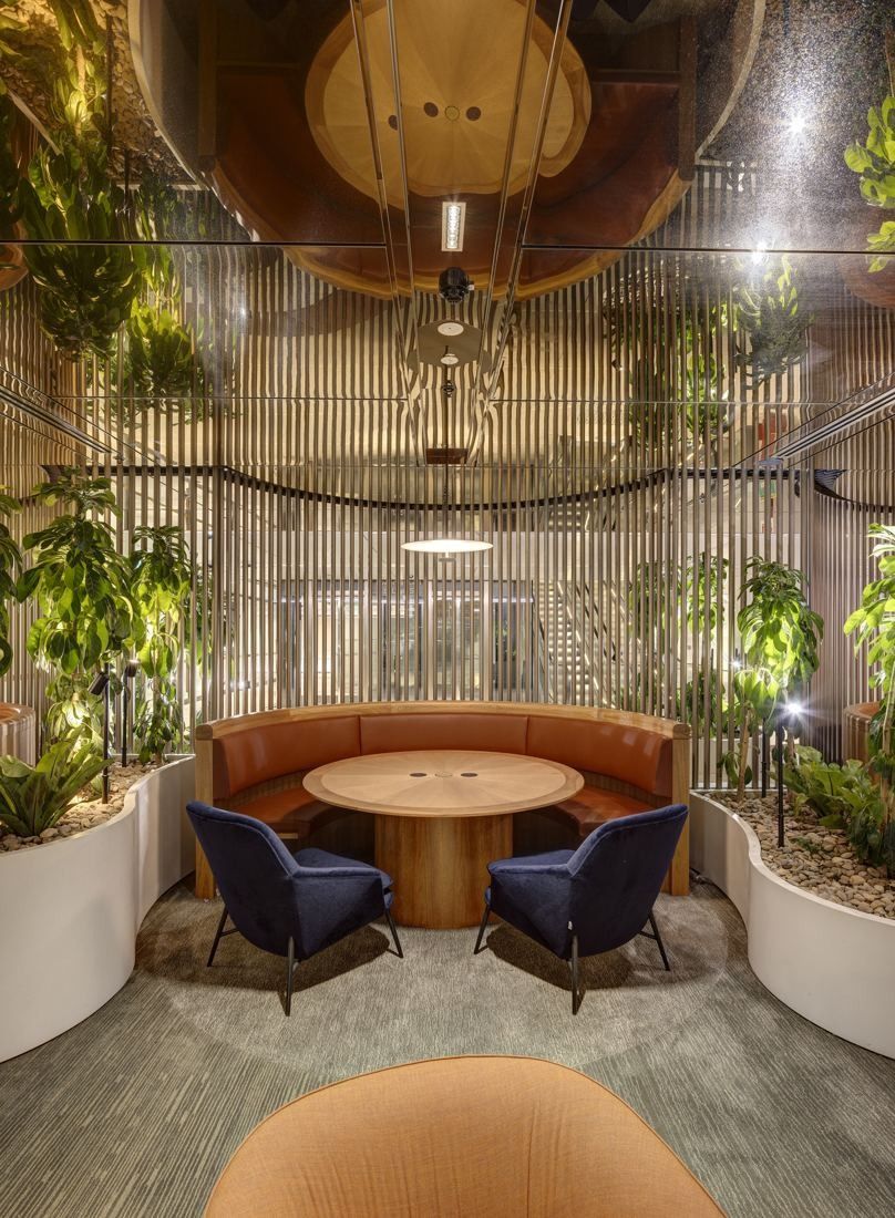 Macquarie Group: Round booth surrounded by plants under a timber ceiling