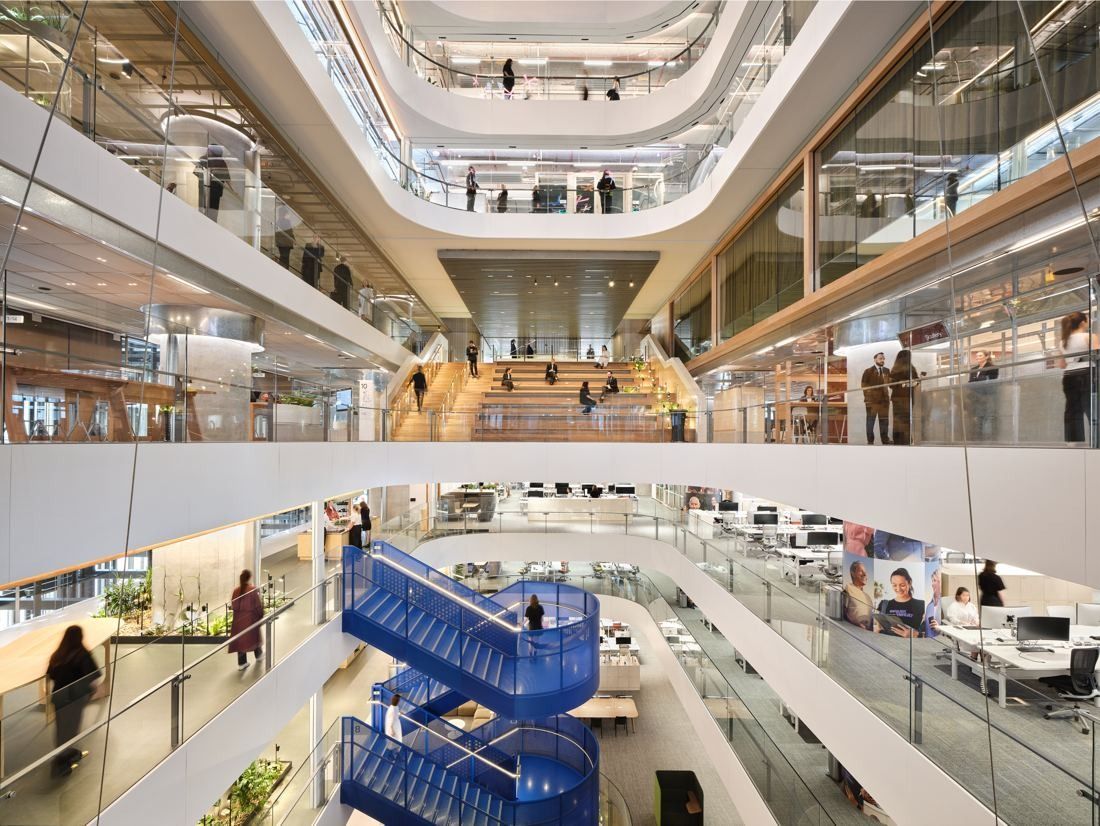 Macquarie Group: Tall atrium with curved balconies and a blue staircase linking the floors