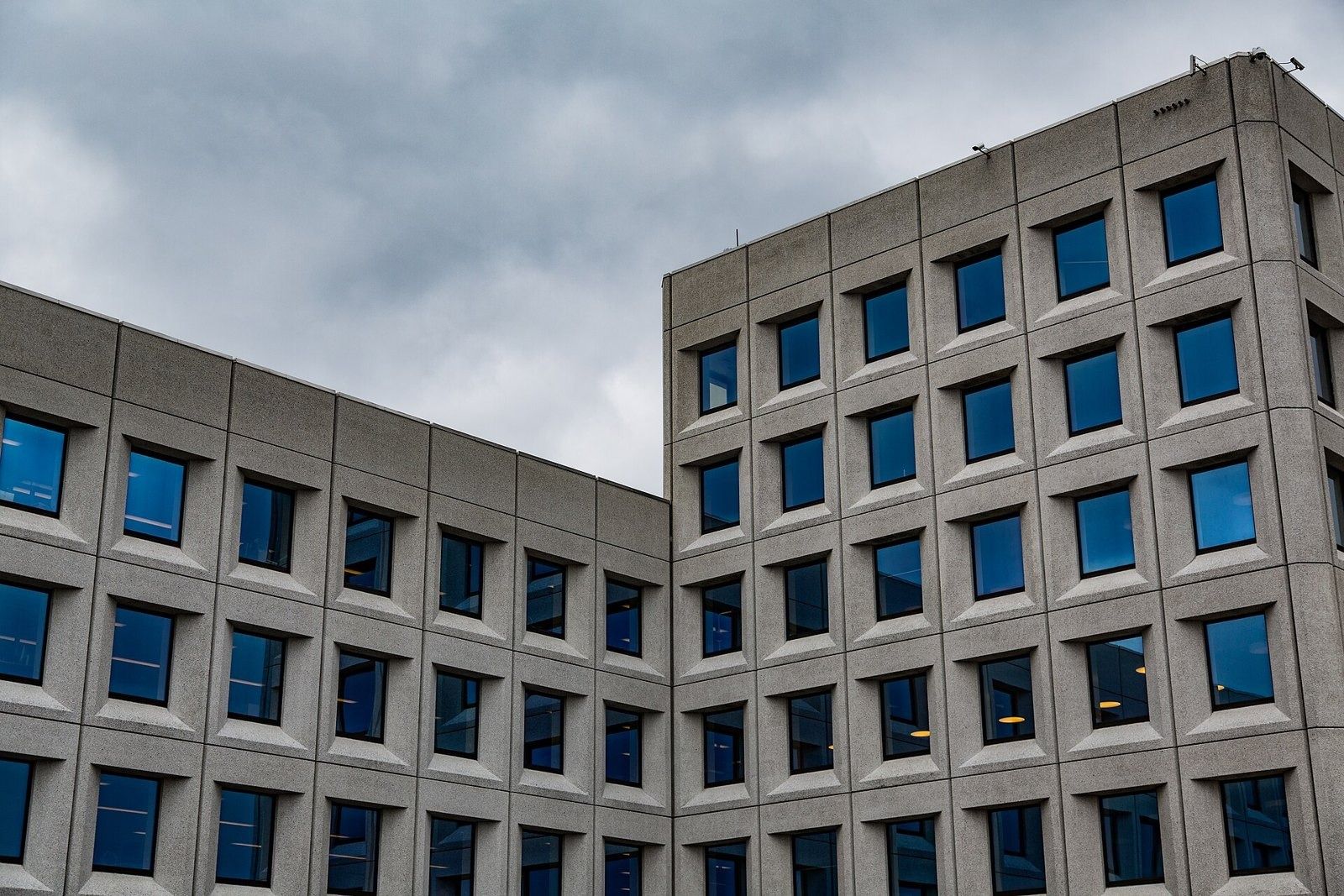 A.P. Moller - Maersk: Inside corner where two concrete wings meet under a cloudy sky