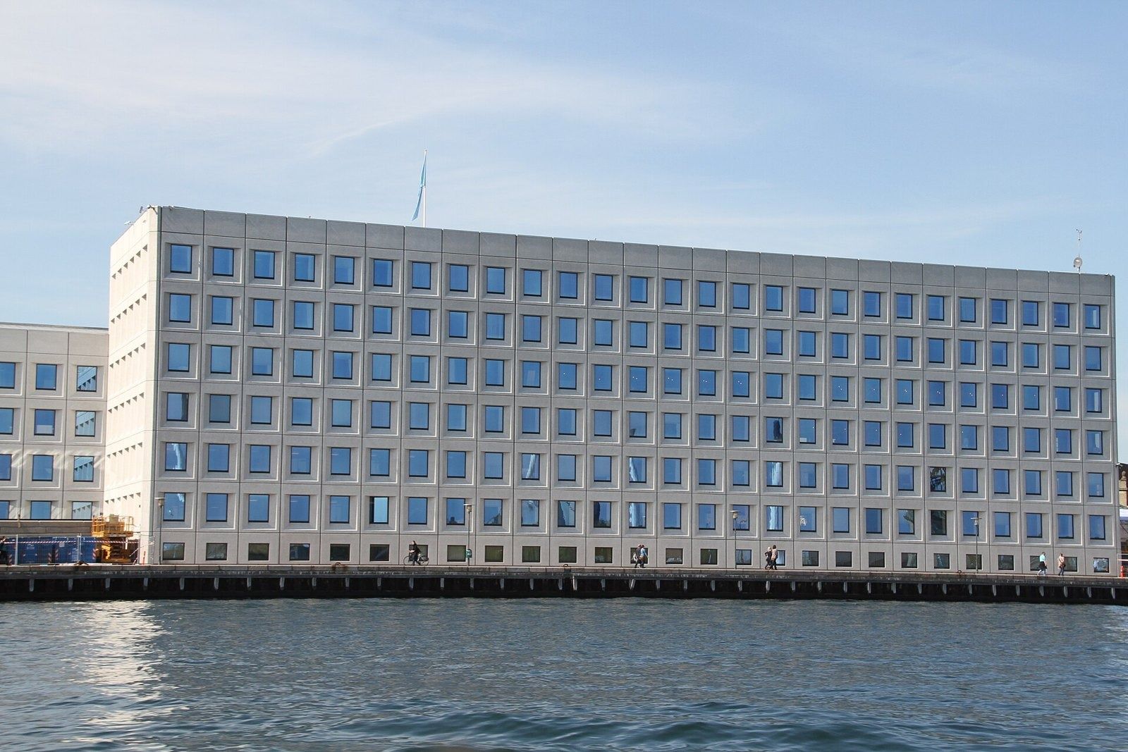 A.P. Moller - Maersk: Long eight-storey facade with a regular window grid above the harbour wall