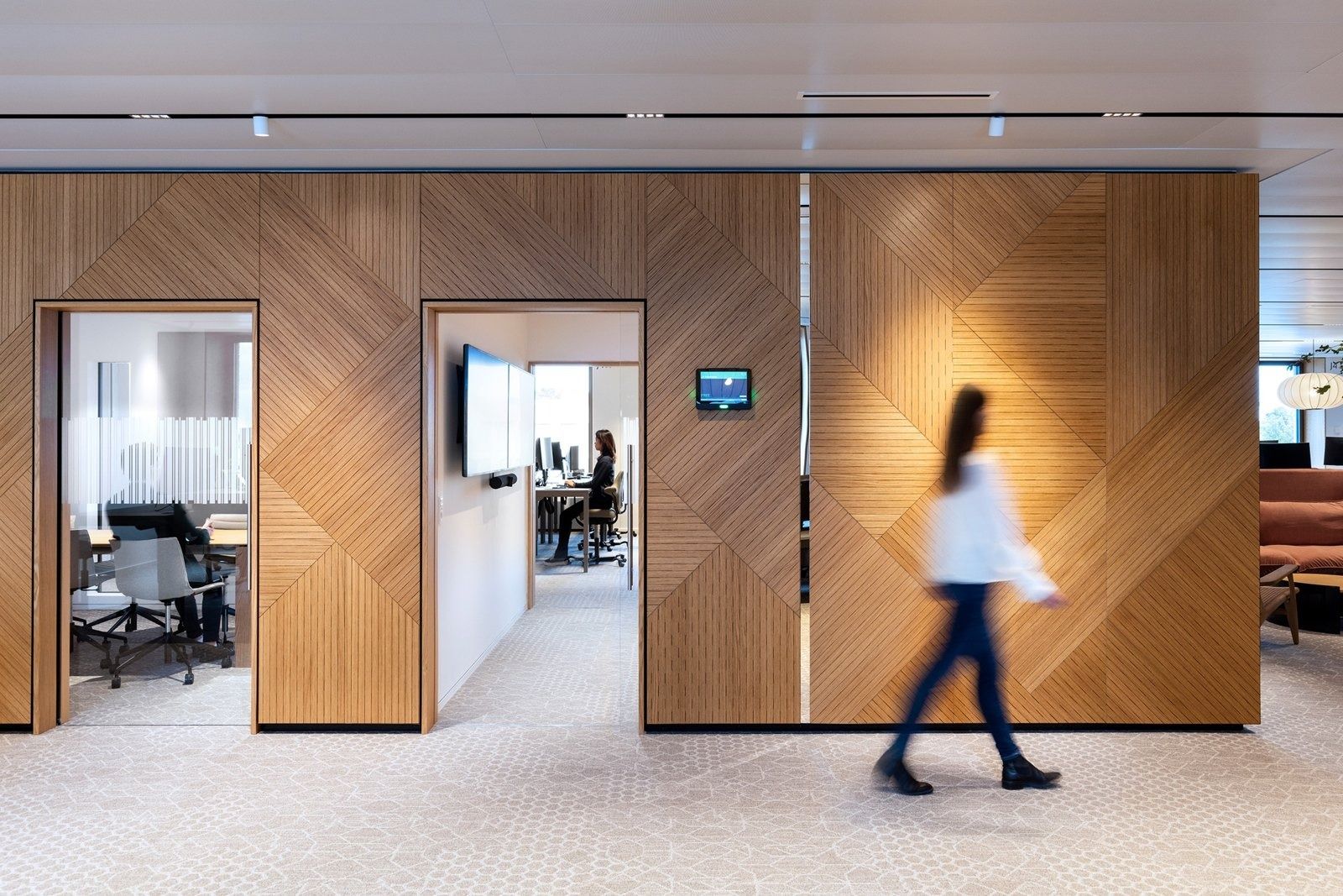 A.P. Moller - Maersk: Oak-clad meeting room block with herringbone panels and open doors on an office floor