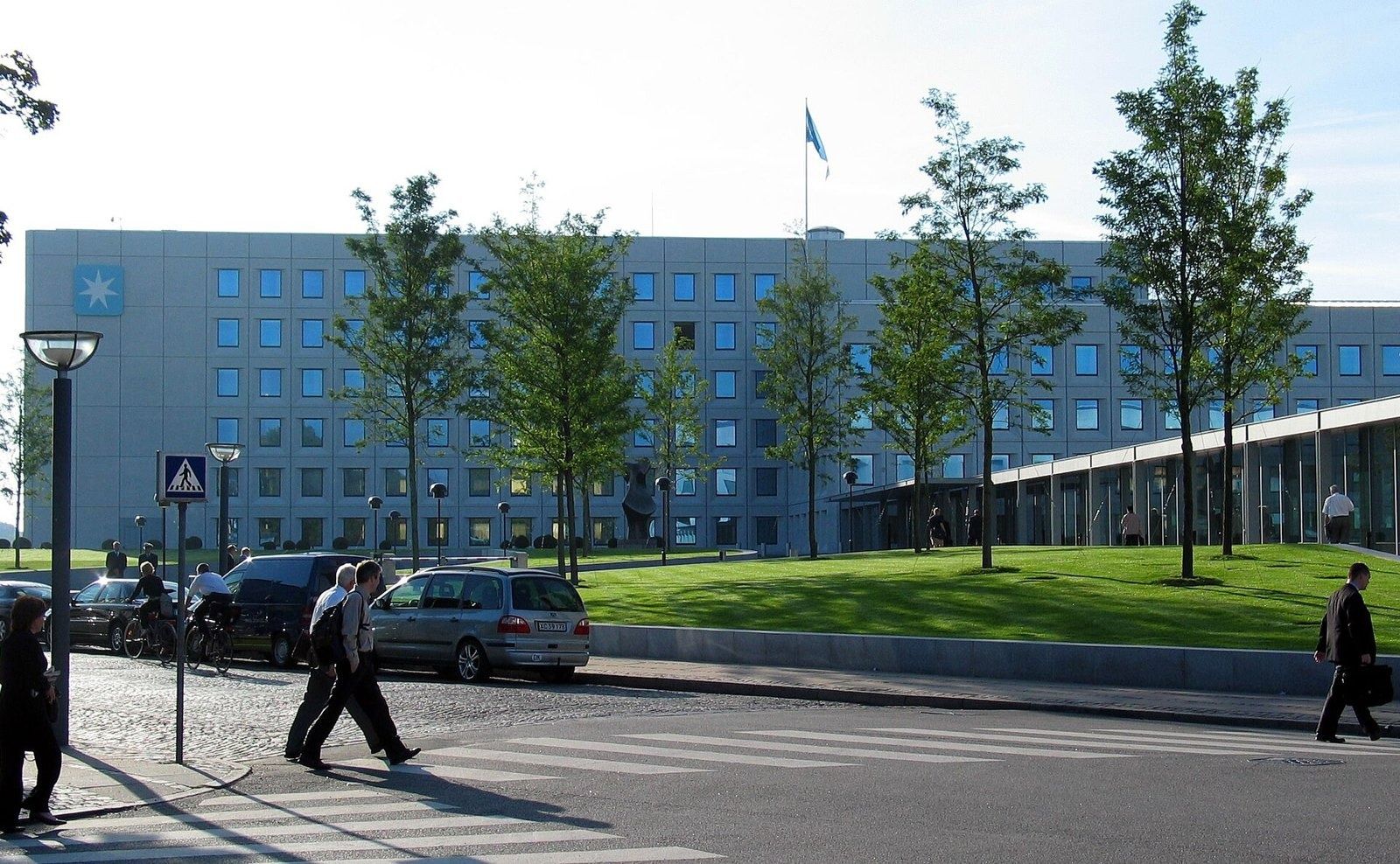 A.P. Moller - Maersk: The building behind a row of young trees and a lawn, with a street crossing in front