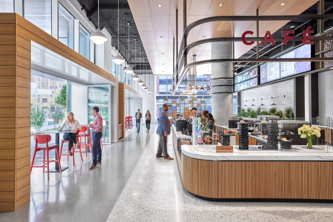Marriott International: Café counter with wooden cladding and red stools along a glass street-side wall
