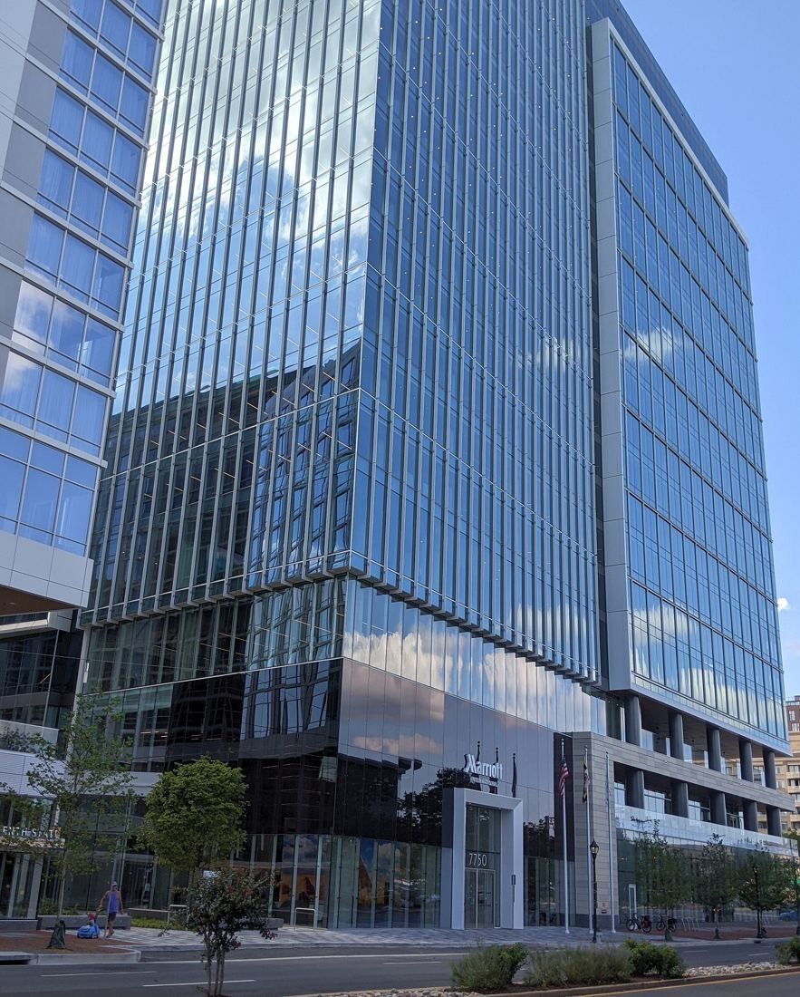 Marriott International: Lower floors of a glass office tower with street trees