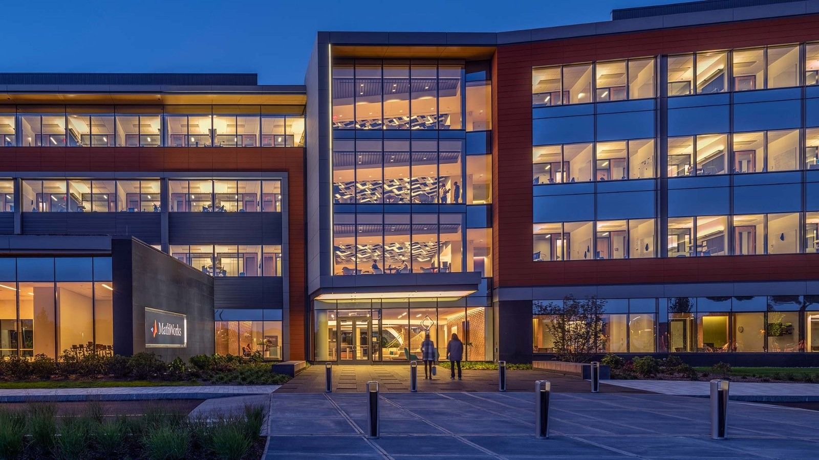 MathWorks: A brick and glass building lit at night