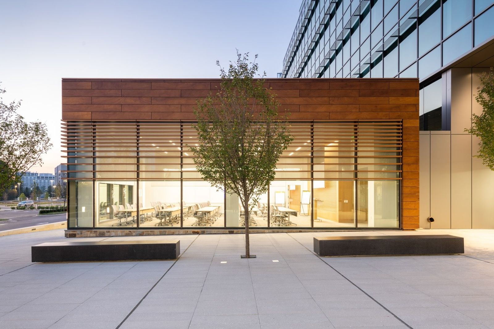 McCormick: Glass pavilion with warm light at dusk