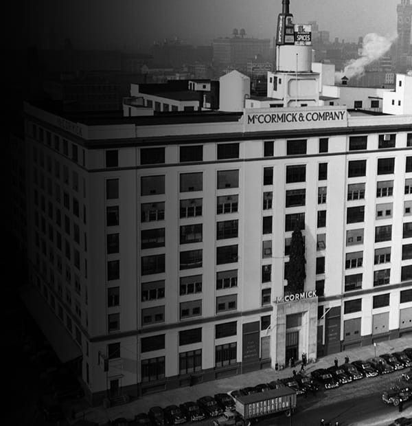 Old photo of a large white building with McCormick on the roof