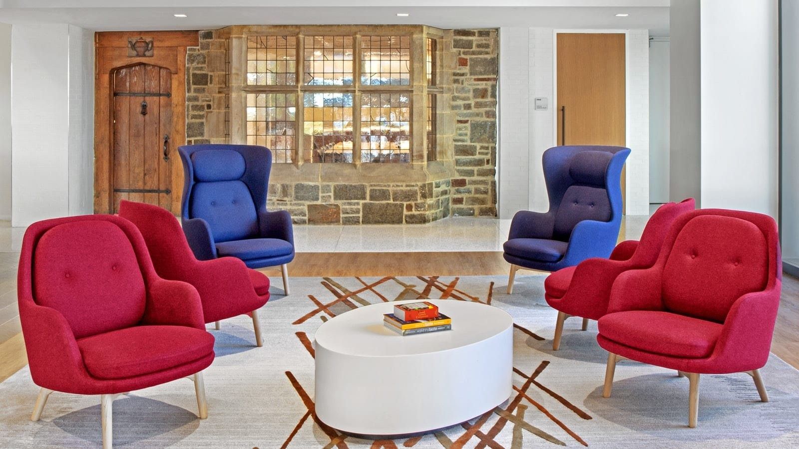 McCormick: Red and blue armchairs in front of an old stone wall and window